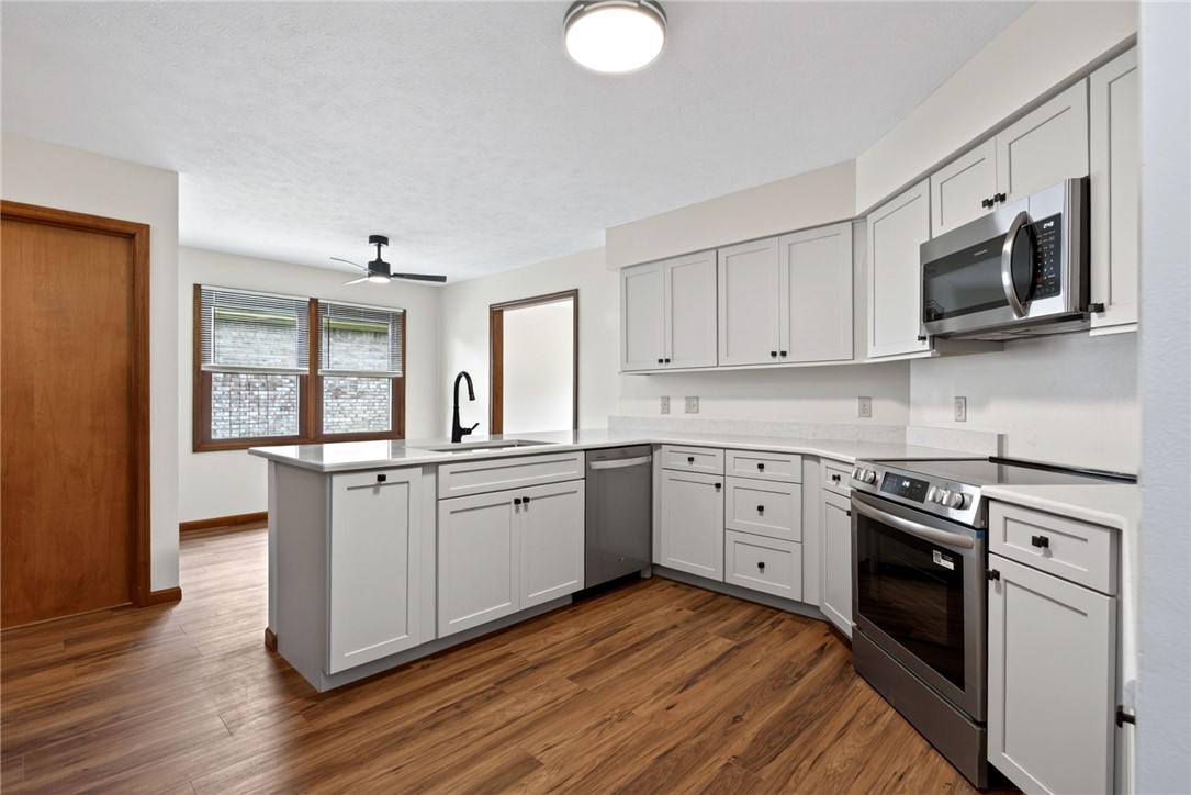 862 Camp Creek Road Waynesville, OH 45068 - Photo 11 of 44 This modern kitchen features crisp cabinetry, sleek quartz countertops, and rich wood flooring.