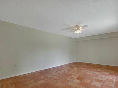 1403 14th Court Jupiter, FL 33477 - Photo 12 of 25 an empty room with a chandelier fan