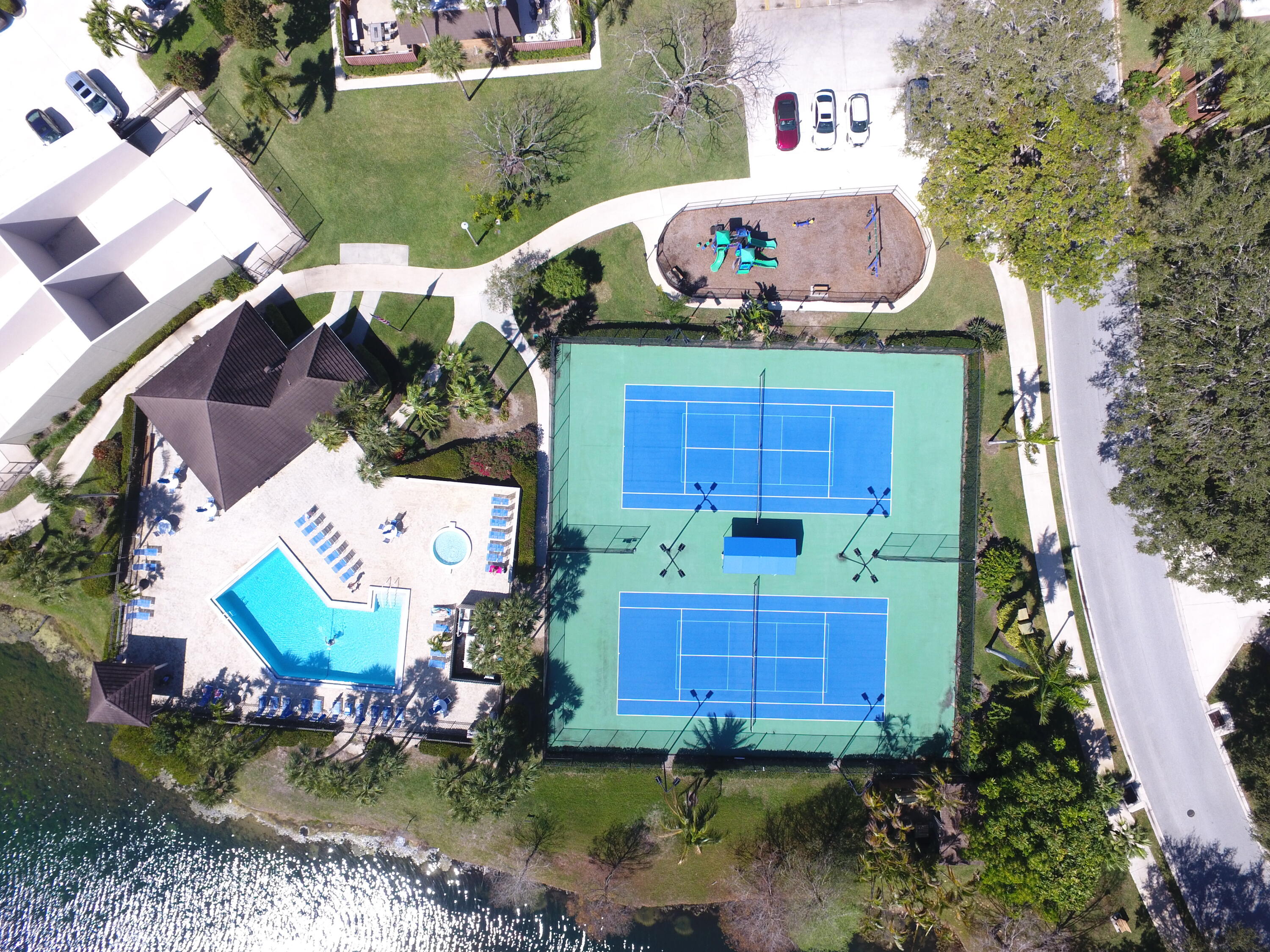 1403 14th Court Jupiter, FL 33477 - Photo 22 of 25 an aerial view of a house with a garden and lake view