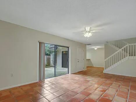 1403 14th Court Jupiter, FL 33477 - Photo 10 of 25 a view of a hallway with a chandelier fan and windows