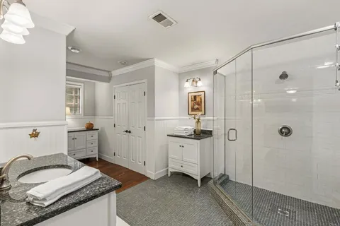 a spacious bathroom with a granite countertop sink mirror and shower