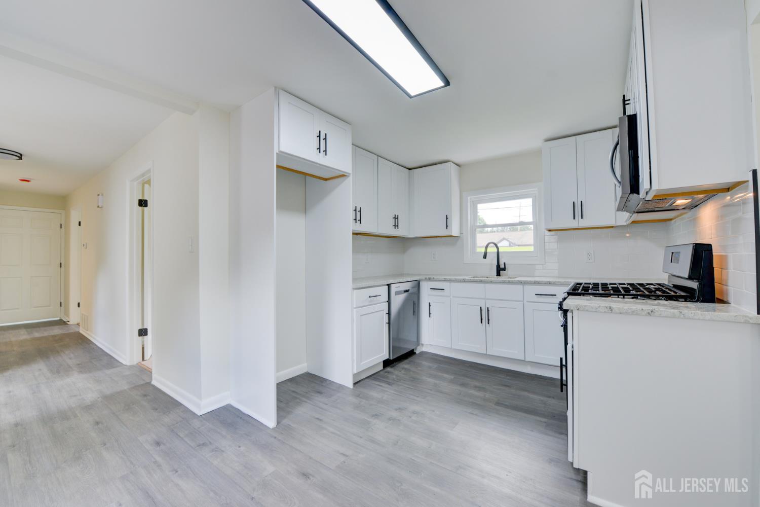 6 Main Street Helmetta, NJ 08828 - Photo 9 of 27 a kitchen with cabinets appliances and a wooden floor