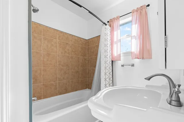 a bathroom with a bathtub and a shower