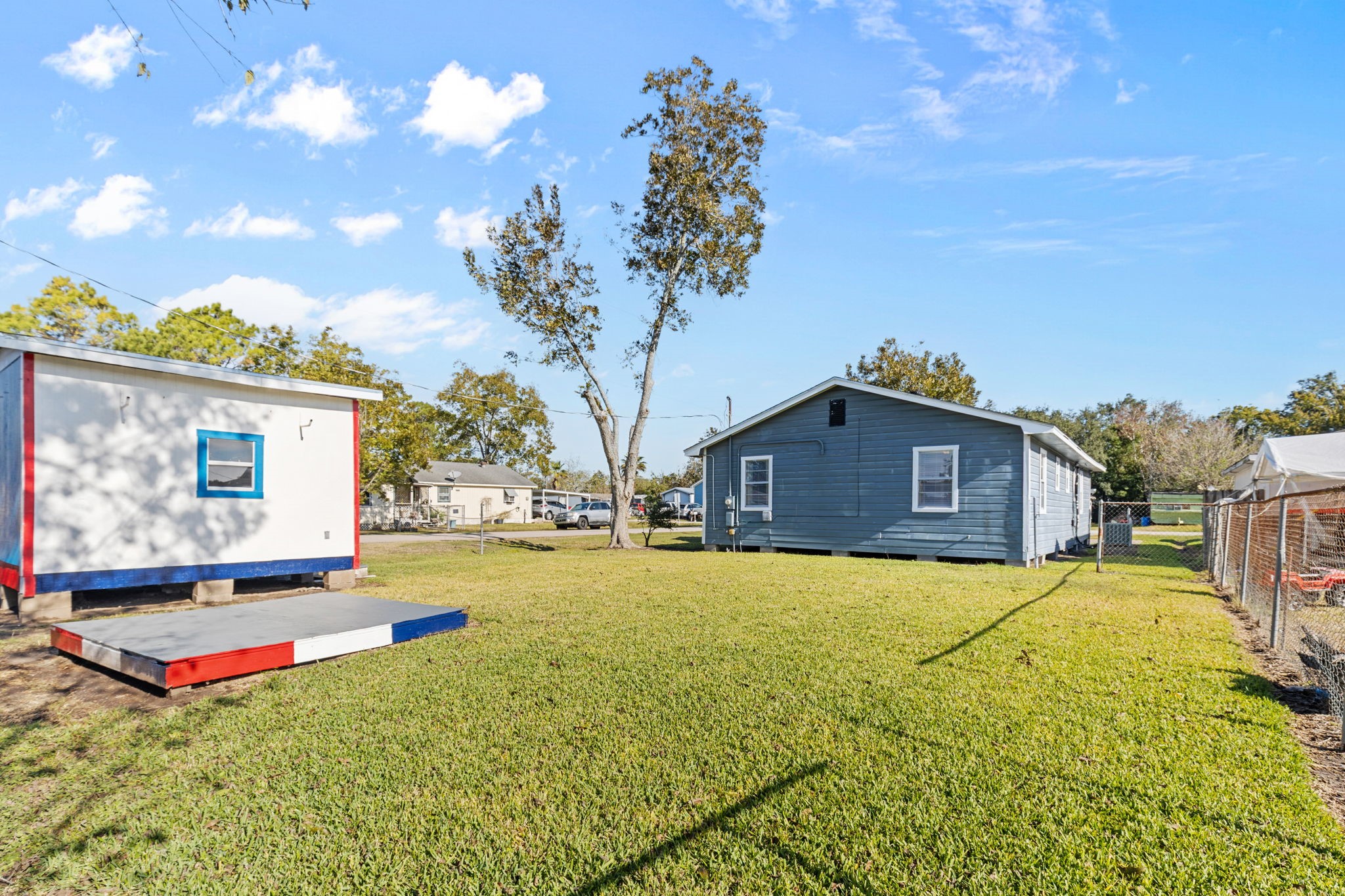 1051 Ave A Bacliff, TX 77518 - Photo 17 of 20 a yellow house with yard in front of it