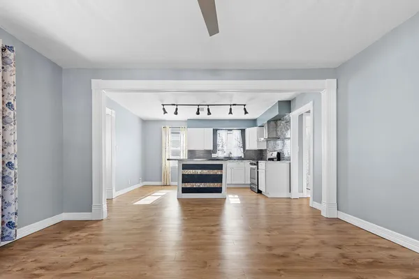 a view of a kitchen with a sink stainless steel appliances and cabinets