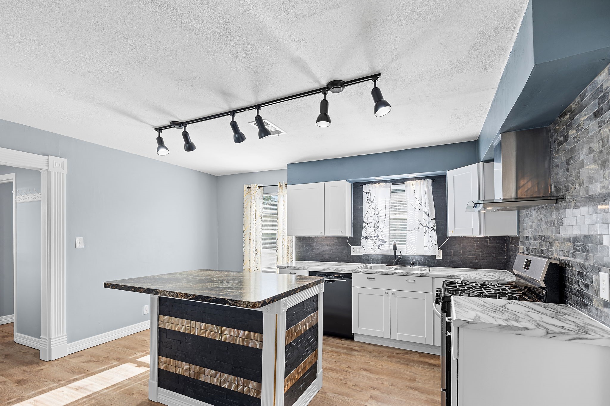 1051 Ave A Bacliff, TX 77518 - Photo 6 of 20 a kitchen with a stove sink and cabinets