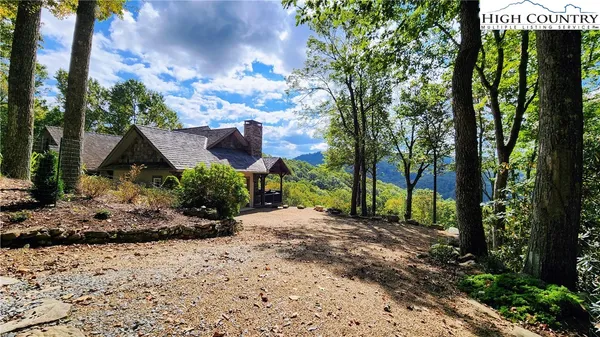 a view of a house with a tree in the background