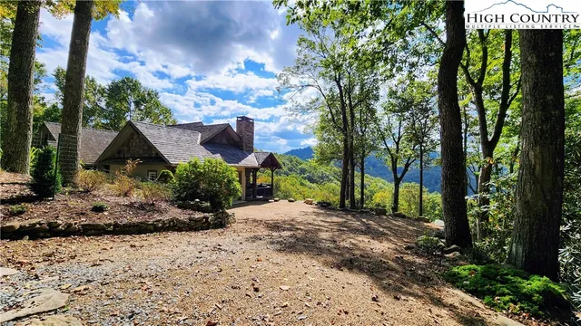 a view of a house with a tree in the background