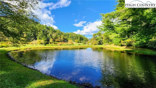 a view of a lake with houses in the back