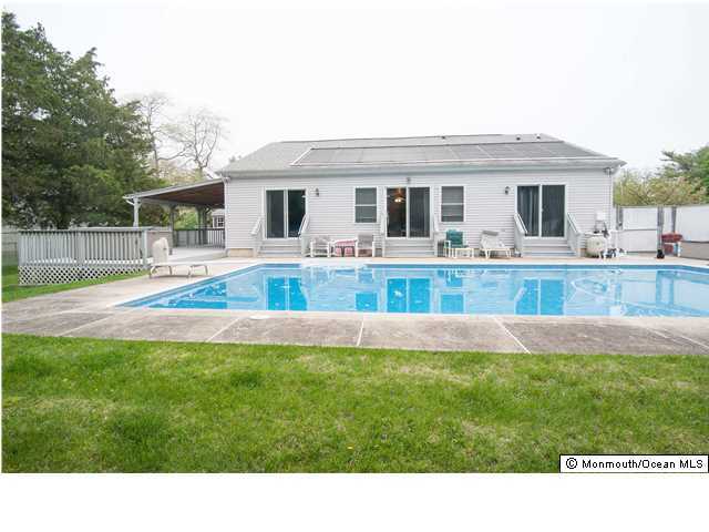 a house view with swimming pool and a yard