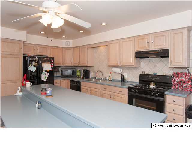 641 Hulses Corner Road Howell, NJ 07731 - Photo 11 of 21 a kitchen with stainless steel appliances kitchen island granite countertop a stove and a refrigerator