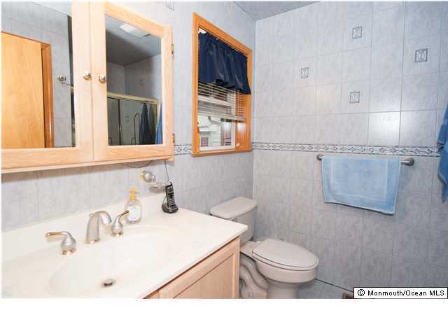 641 Hulses Corner Road Howell, NJ 07731 - Photo 14 of 21 a bathroom with a sink a toilet and mirror