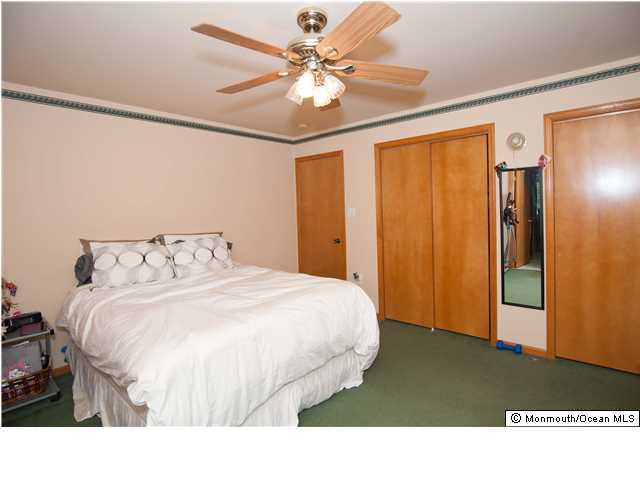 641 Hulses Corner Road Howell, NJ 07731 - Photo 15 of 21 a bedroom with a bed and a chandelier