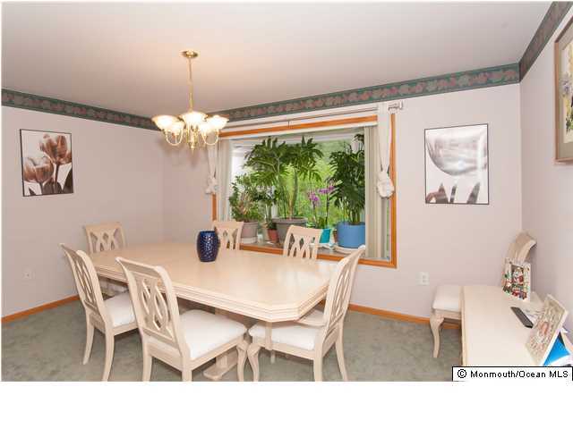 641 Hulses Corner Road Howell, NJ 07731 - Photo 8 of 21 a view of a dining room with furniture a chandelier and large windows