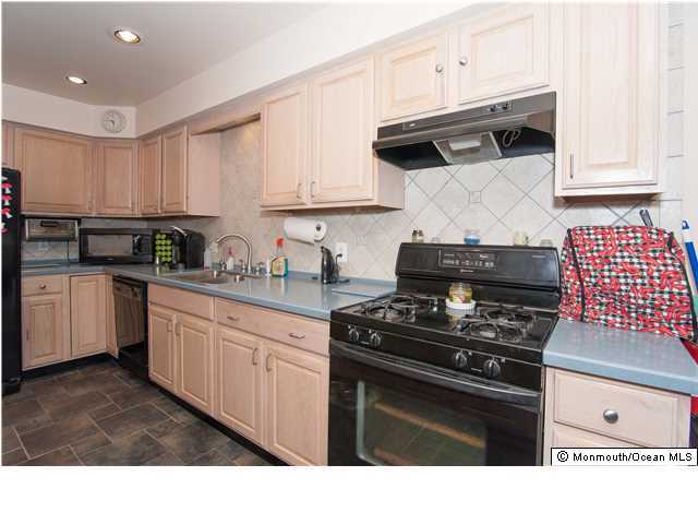 641 Hulses Corner Road Howell, NJ 07731 - Photo 9 of 21 a kitchen with stainless steel appliances granite countertop white cabinets and black stove top oven with granite countertops