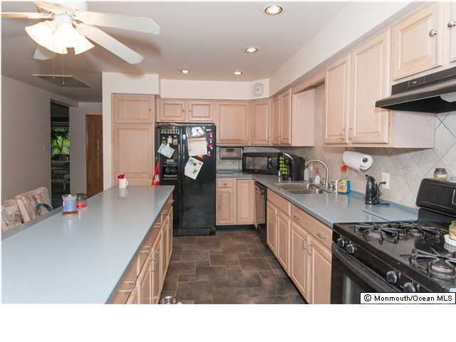 641 Hulses Corner Road Howell, NJ 07731 - Photo 10 of 21 a kitchen with kitchen island granite countertop a sink cabinets and stainless steel appliances
