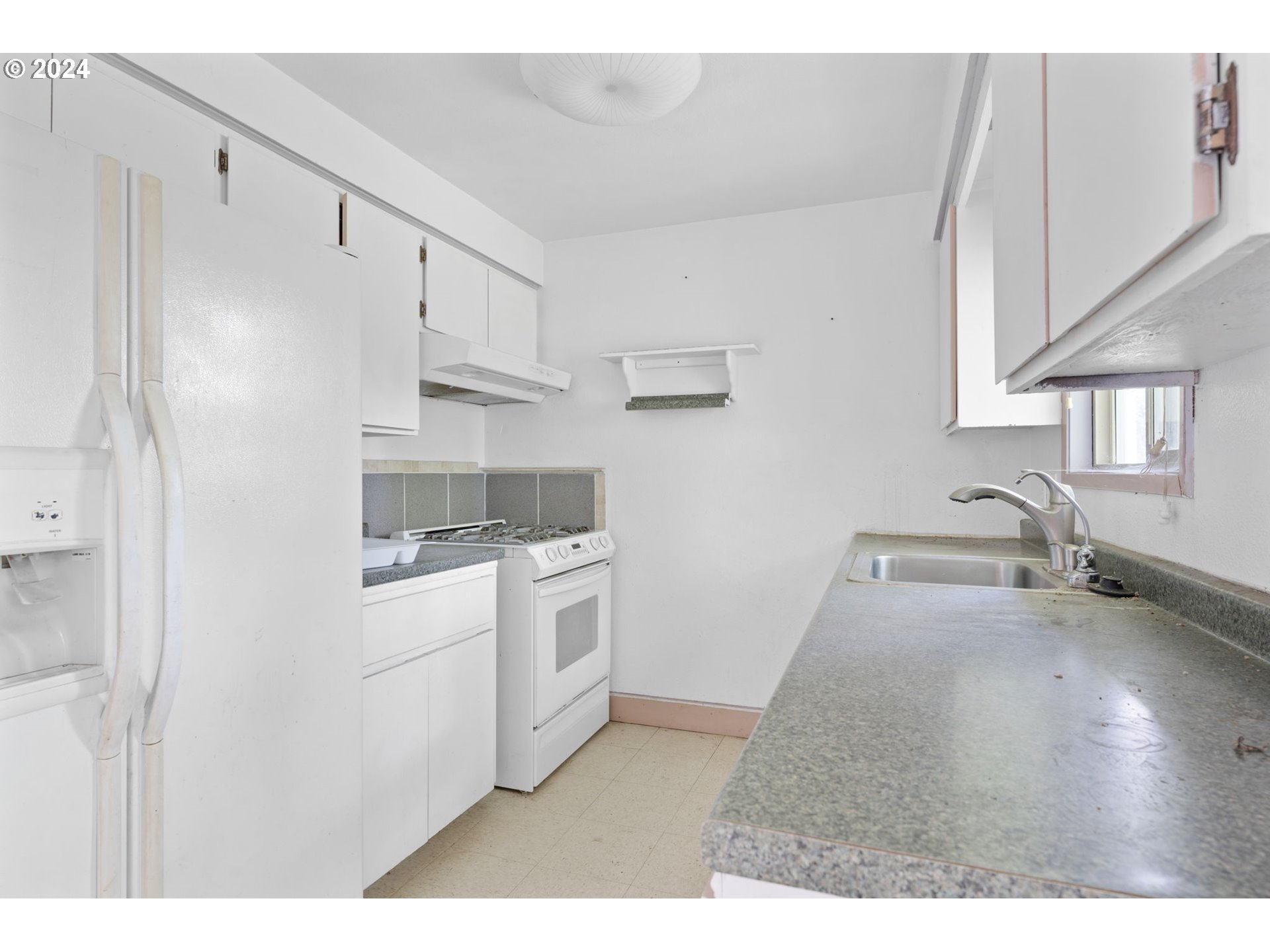 8707 Southeast Cottrell Road Boring, OR 97009 - Photo 12 of 44 a kitchen with stainless steel appliances granite countertop a sink stove and refrigerator
