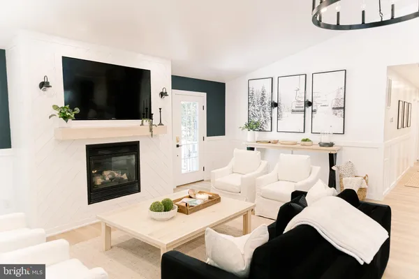 a bedroom with a bed and a flat tv screen on dresser