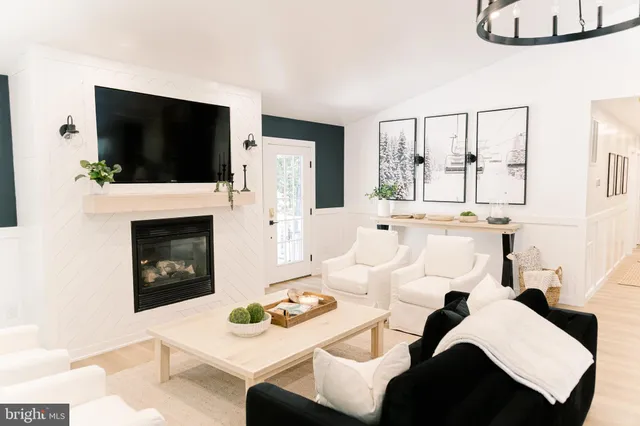 a bedroom with a bed and a flat tv screen on dresser