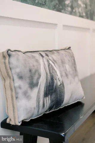 a room with a table chairs a flat screen tv and a kitchen view