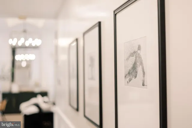a bathroom with a potted plant on the counter and a window