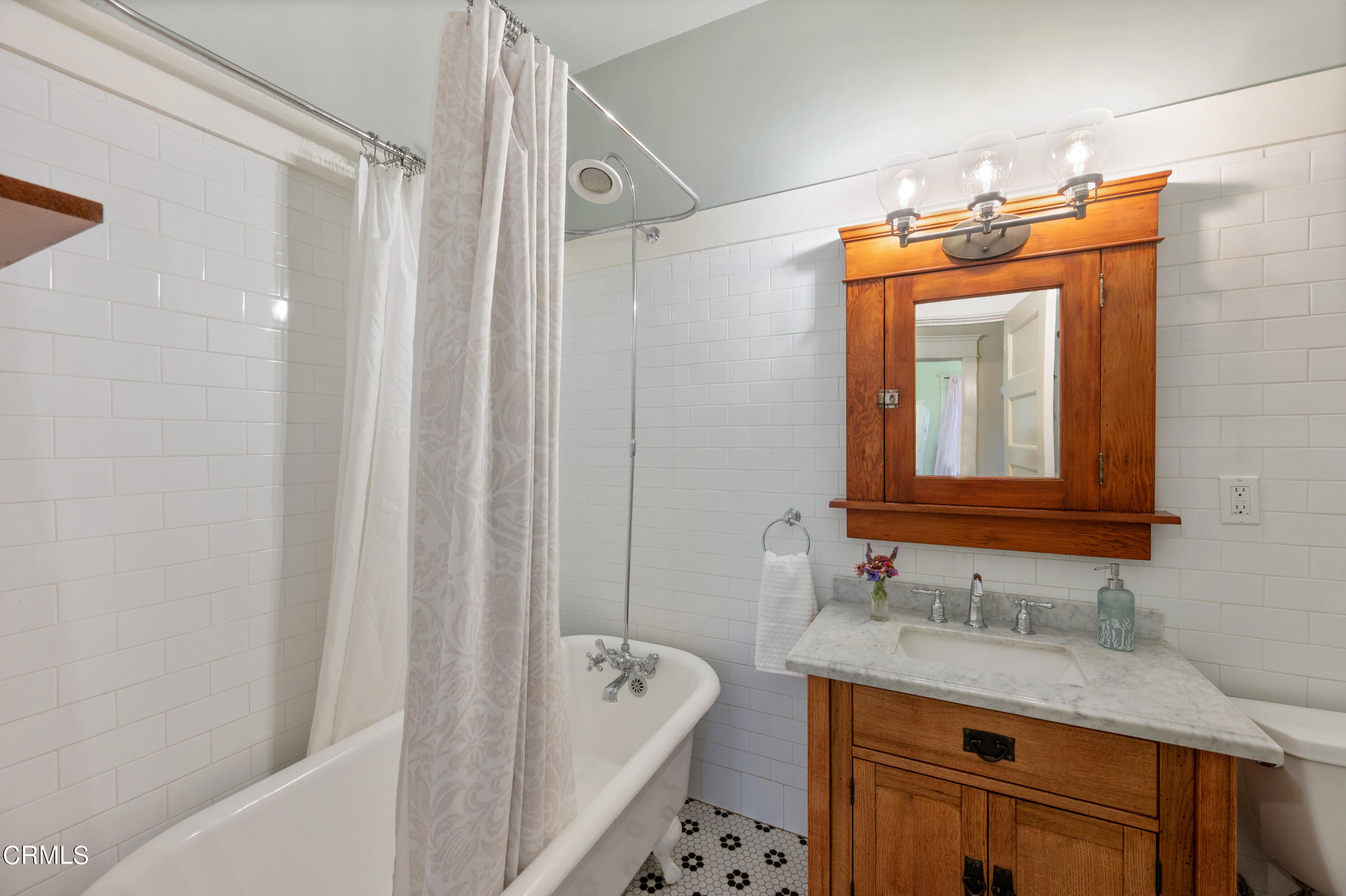 1265 North Wilson Avenue Pasadena, CA 91104 - Photo 22 of 48 a bathroom with a granite countertop sink a mirror a vanity and a bathtub