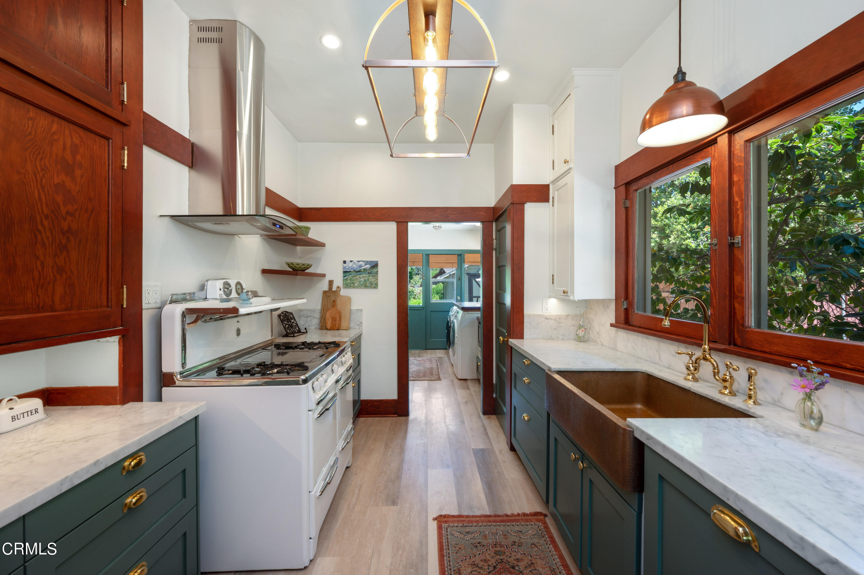 1265 North Wilson Avenue Pasadena, CA 91104 - Photo 9 of 48 a kitchen with a sink a counter top space stainless steel appliances a large window and cabinets