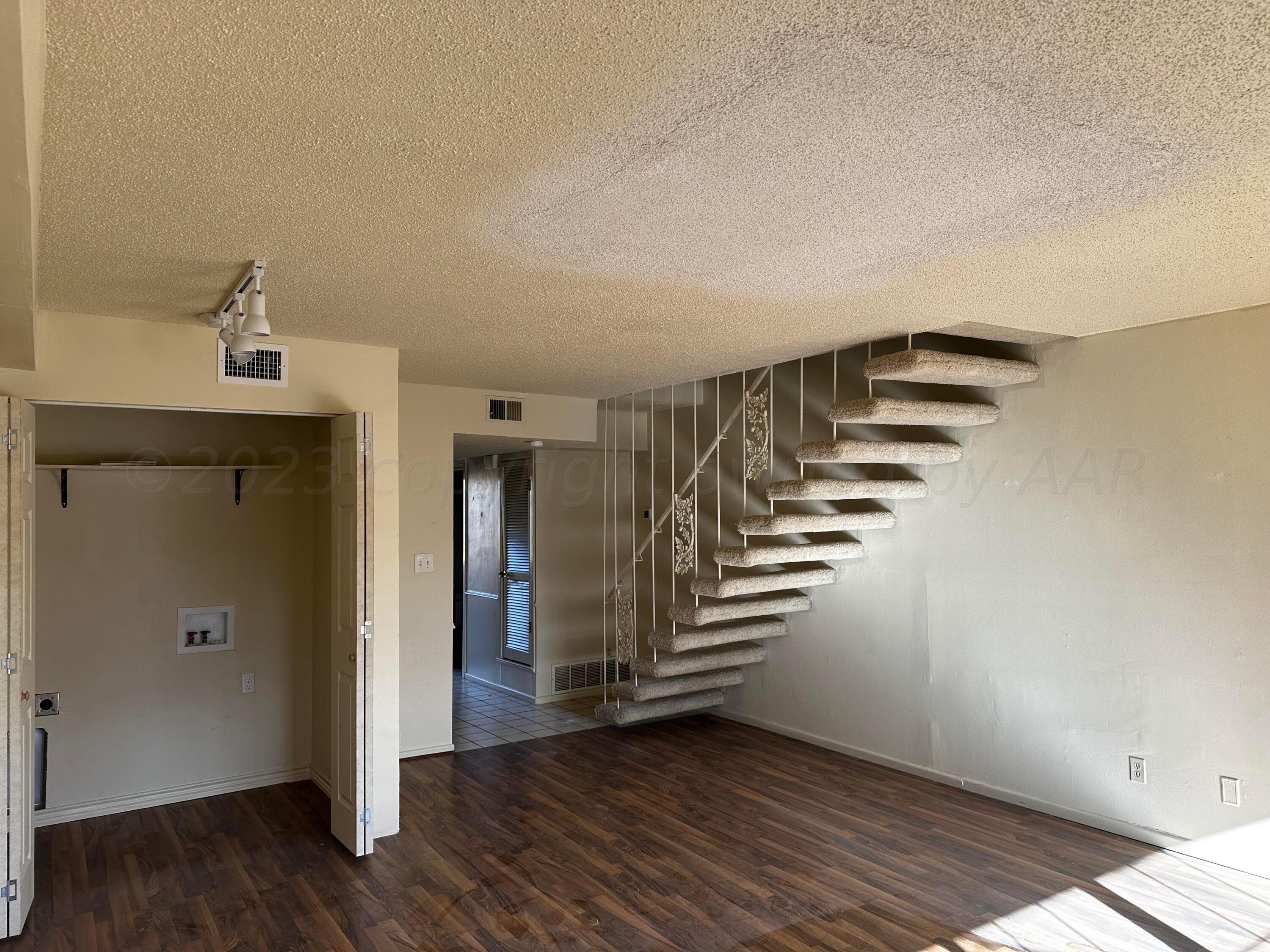 3219 Villa Place Amarillo, TX 79109 - Photo 3 of 13 a view of entryway with stairs and wooden floor