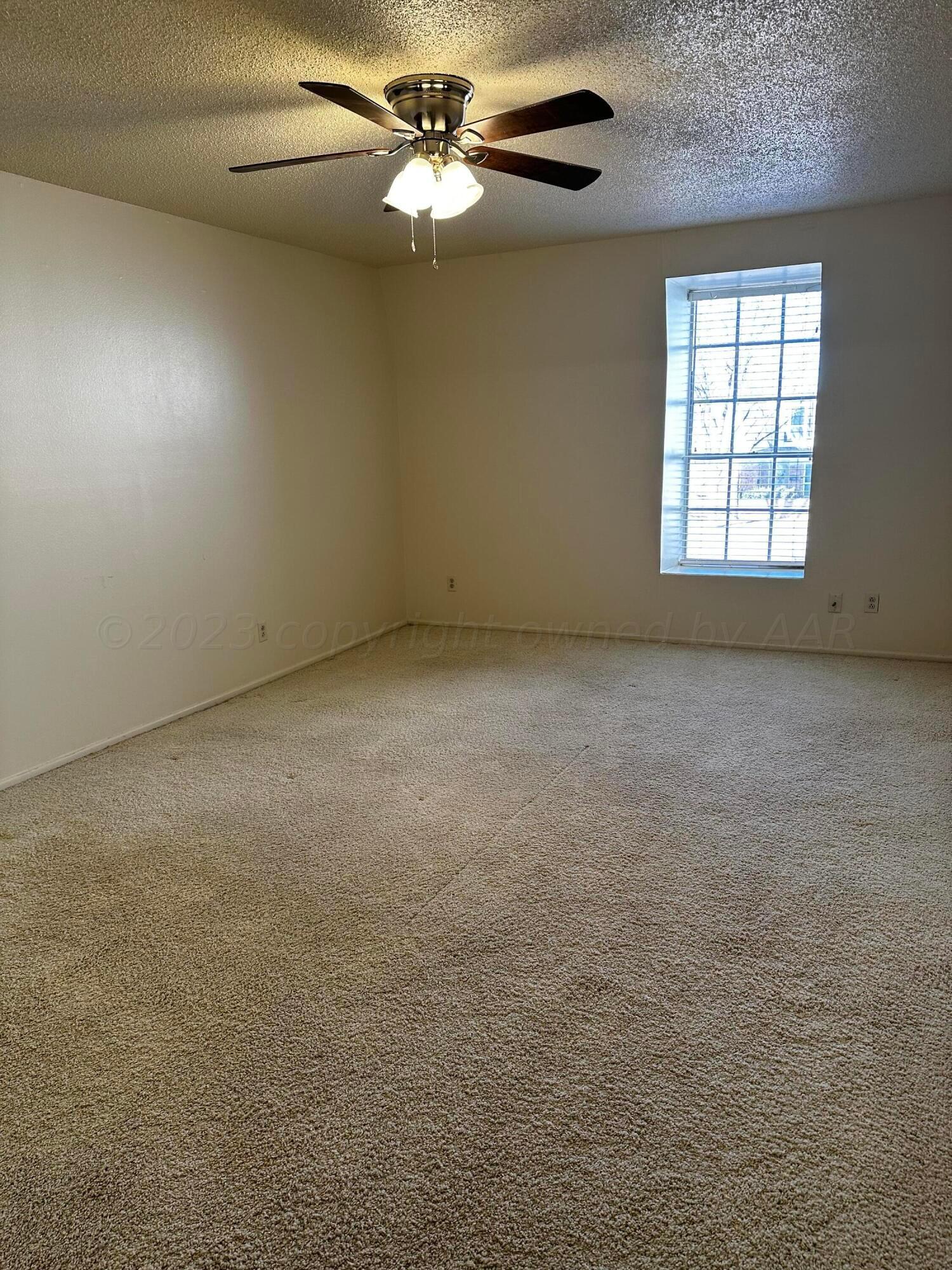 3219 Villa Place Amarillo, TX 79109 - Photo 6 of 13 an empty room with windows and fan