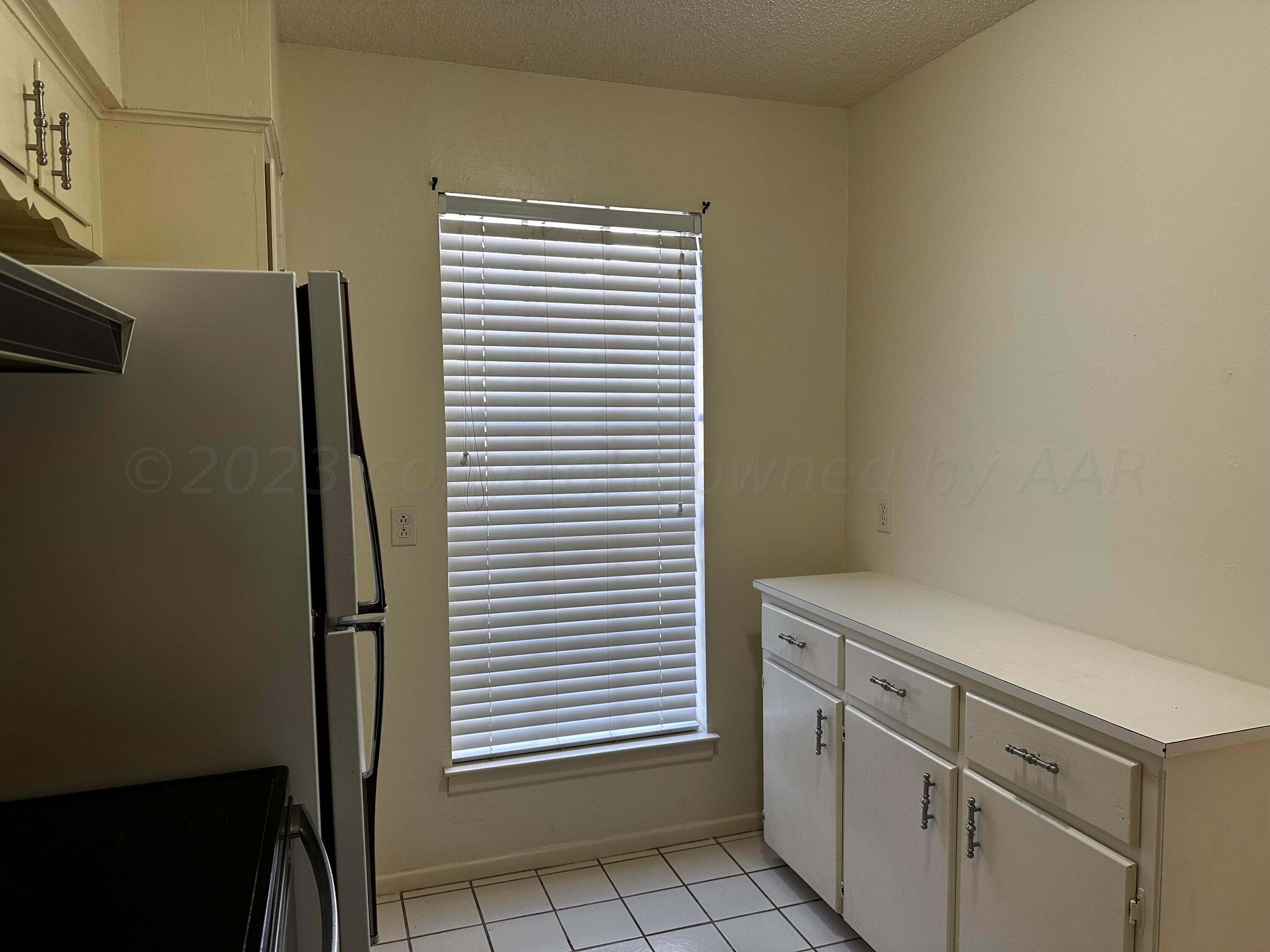 3219 Villa Place Amarillo, TX 79109 - Photo 10 of 13 a view of a kitchen with white cabinets