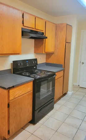 a stove top oven sitting inside of a kitchen