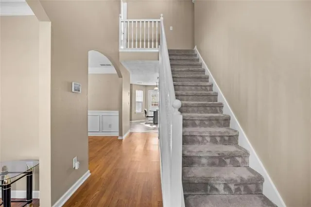 a view of entryway and hall with wooden floor