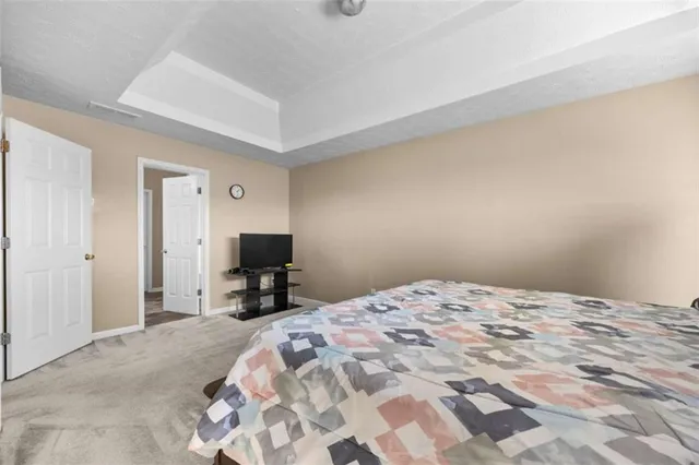 a bedroom with a bed and a chair