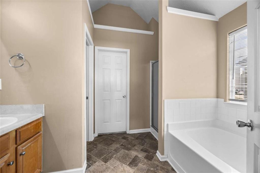 100 Adelaide Drive Covington, GA 30016 - Photo 18 of 33 a bathroom with a bathtub