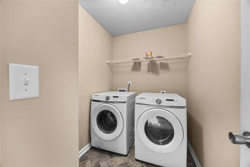 100 Adelaide Drive Covington, GA 30016 - Photo 21 of 33 a utility room with dryer and washer
