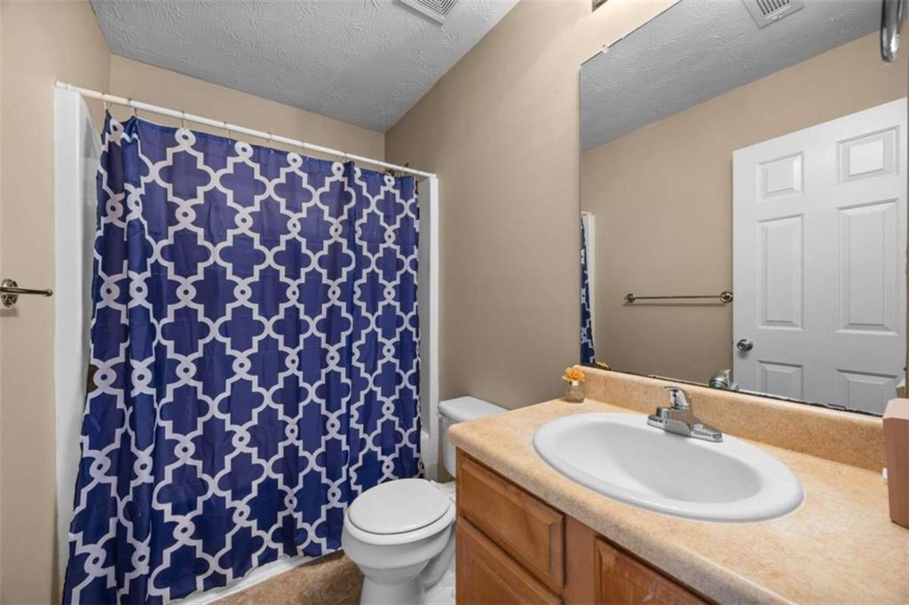 100 Adelaide Drive Covington, GA 30016 - Photo 24 of 33 a bathroom with a sink and a toilet