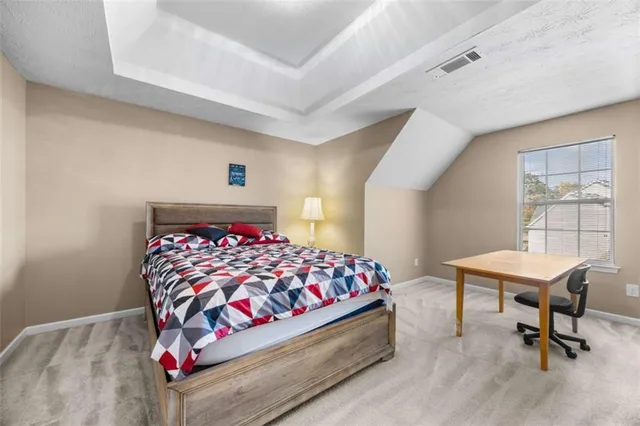 a bedroom with a bed and a table