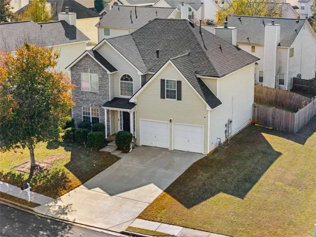 a aerial view of a house with a yard