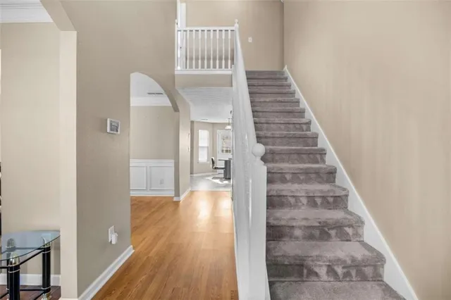 a view of entryway and hall with wooden floor