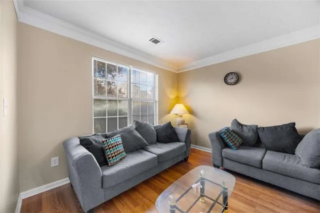 a living room with furniture a couch and a window
