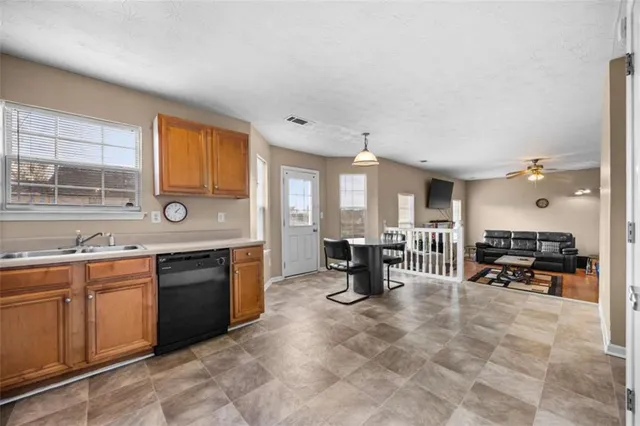 a large kitchen with lots of counter furniture and a sink