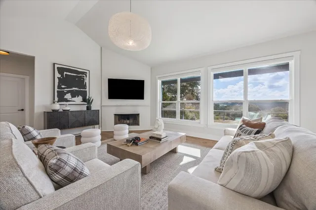 a living room with furniture fireplace and a flat screen tv