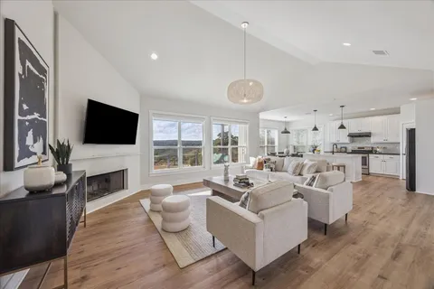 a living room with fireplace furniture and a flat screen tv