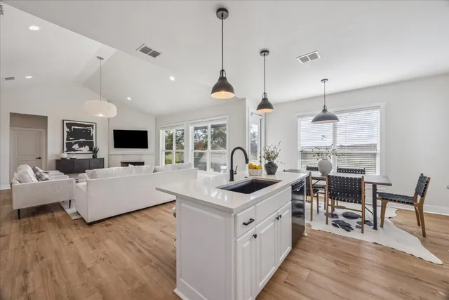 a open kitchen with stainless steel appliances granite countertop a stove and a wooden floors