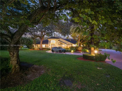 a kitchen with stainless steel appliances kitchen island granite countertop a sink and cabinets