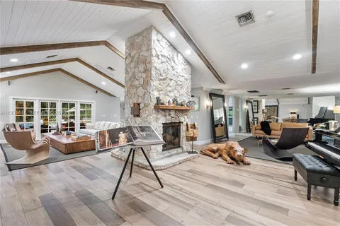 a view of a patio with couches and a table and chairs under an umbrella