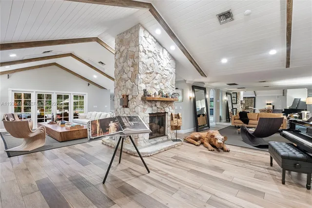 a view of a patio with couches and a table and chairs under an umbrella