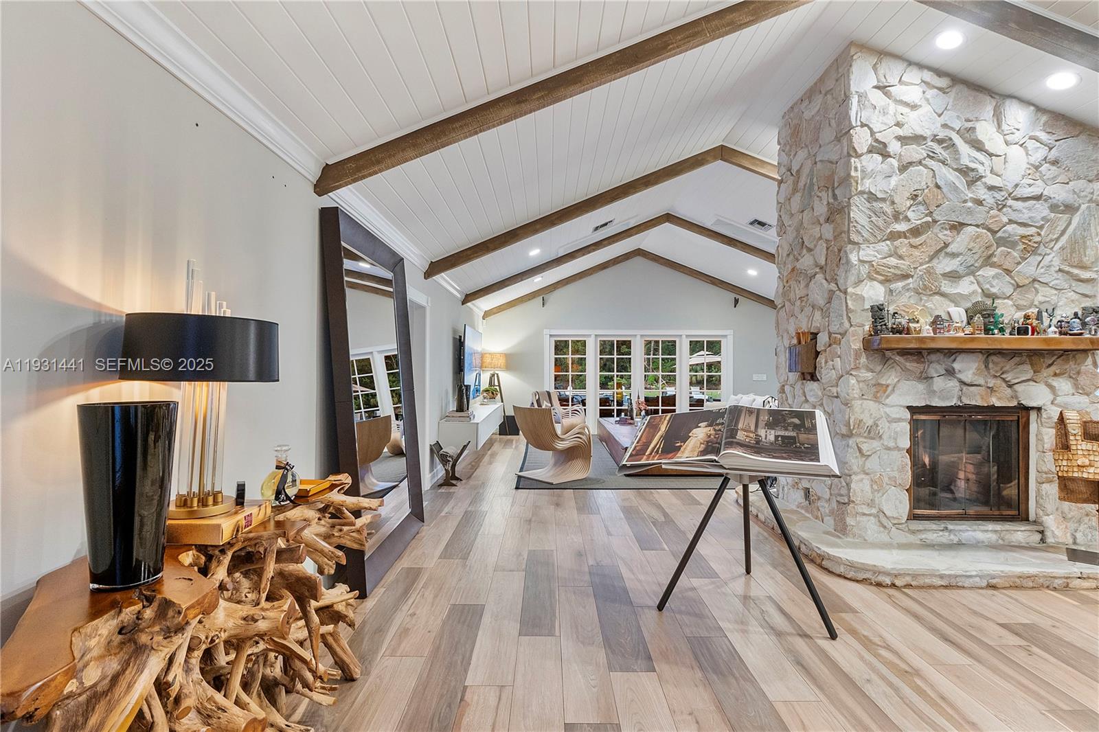 8020 Northwest 47th Drive Coral Springs, FL 33067 - Photo 28 of 83 a living room with furniture a fireplace and a flat screen tv