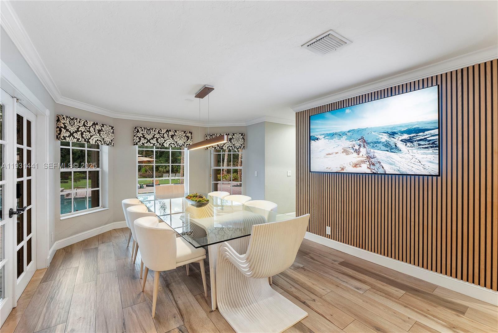 8020 Northwest 47th Drive Coral Springs, FL 33067 - Photo 31 of 83 a view of a dining room with furniture large window and wooden floor