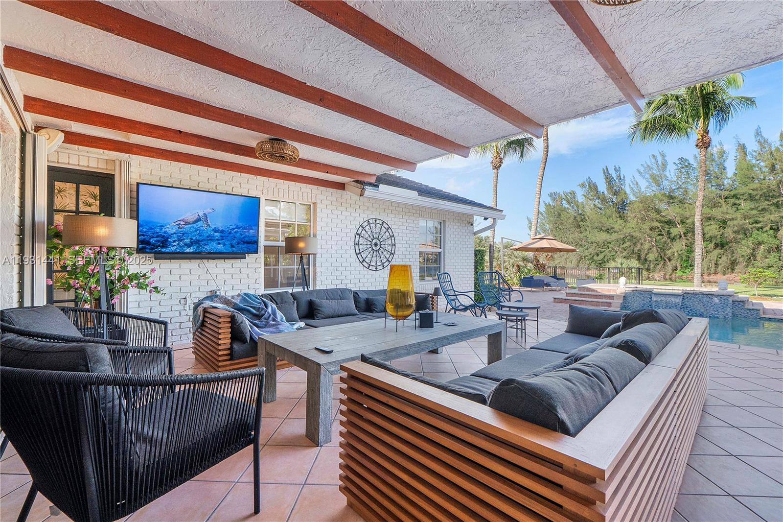 8020 Northwest 47th Drive Coral Springs, FL 33067 - Photo 35 of 83 a living room with furniture and a potted plant